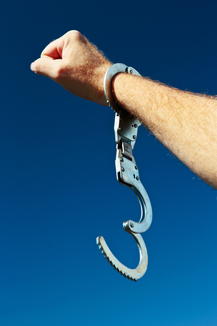 Person freed from handcuffs, symbolizing effective bail bonding services in Concord, NC
